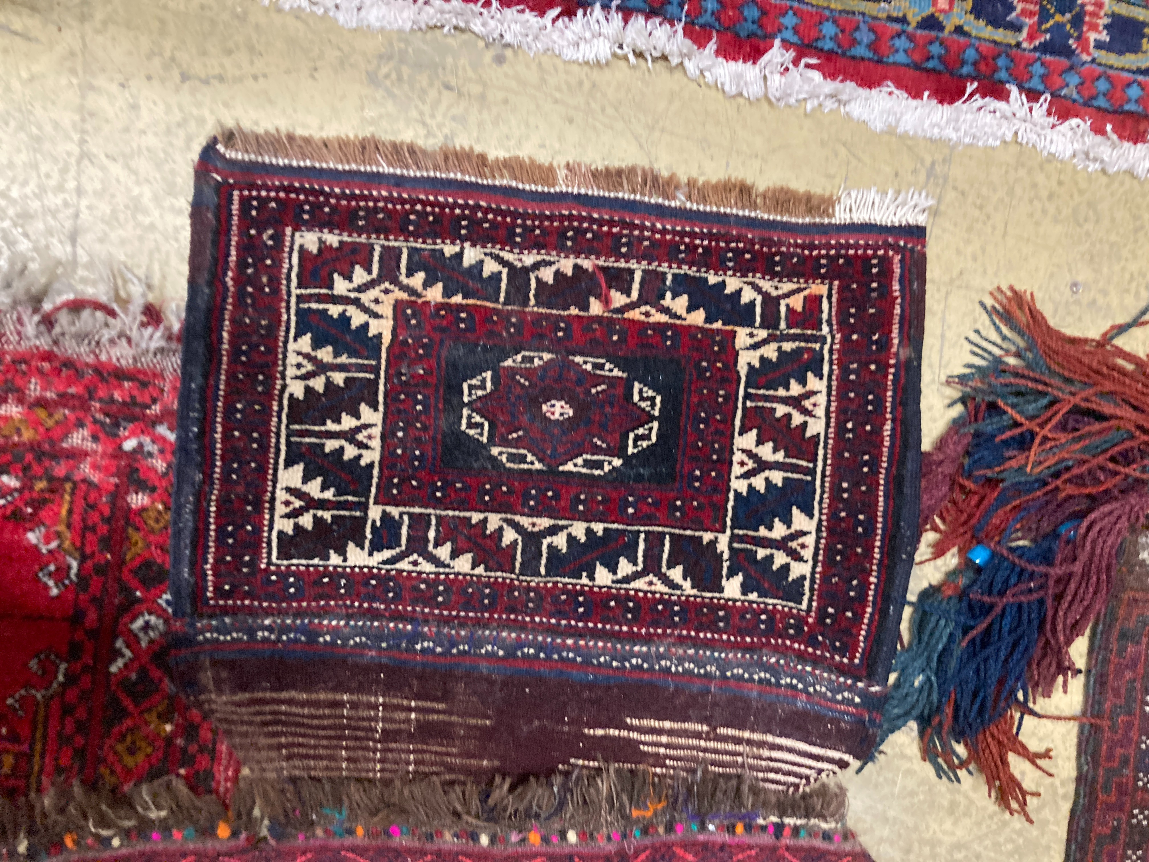 A Bokhara wall hanging 54 x 70 cms, one other, two Bokhara mats and bag.